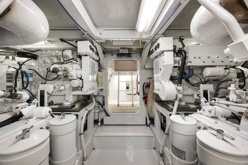 Slide: The Image of Engine room of a 1995 Merritt 65 Sport Fish boat, showcasing machinery and equipment. - 26