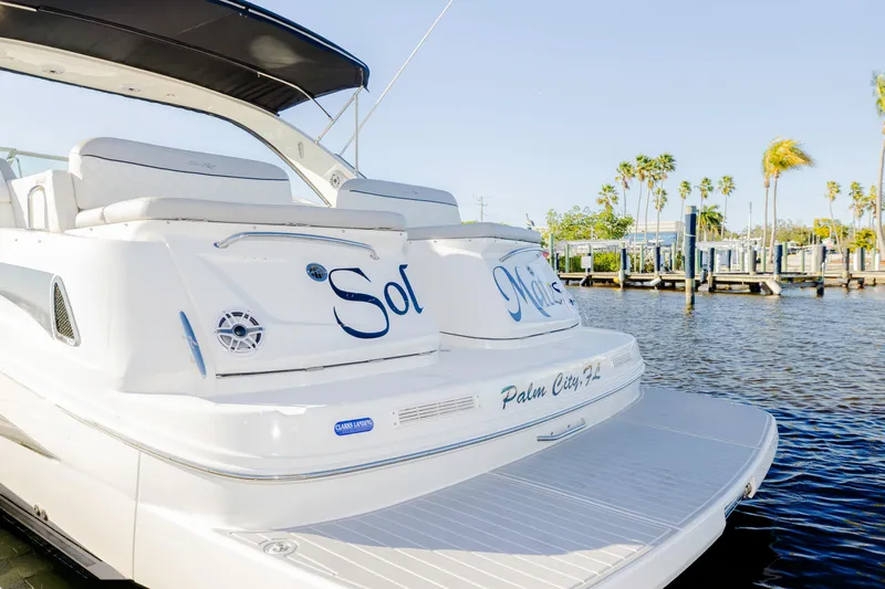 Slide: The Image of 2013 Sea Ray 370 Venture yacht docked in Palm City, Florida, with palm trees in background. - 31