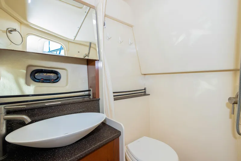 Slide: The Image of 2013 Sea Ray 370 Venture bathroom with modern sink, mirror, and shower. - 37