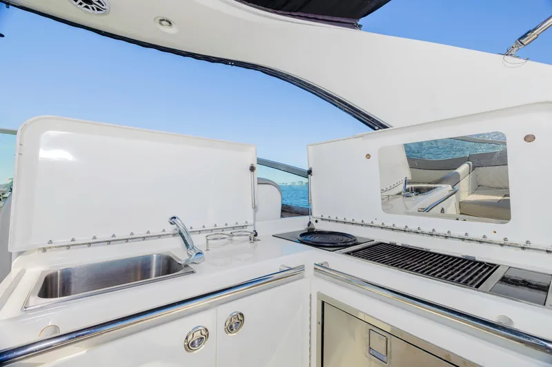 Slide: The Image of 2013 Sea Ray 370 Venture yacht kitchen with sink and grill, ocean view. - 6