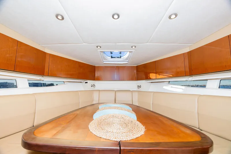 Slide: The Image of Interior of 2013 Sea Ray 370 Venture yacht with elegant dining area and wooden cabinetry. - 19