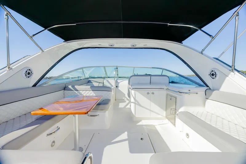 Slide: The Image of Interior of 2013 Sea Ray 370 Venture yacht with seating and table under canopy. - 32