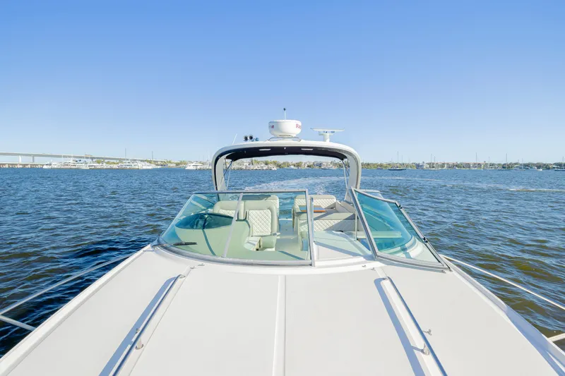 Slide: The Image of 2013 Sea Ray 370 Venture cruising on open water under clear blue skies. - 16