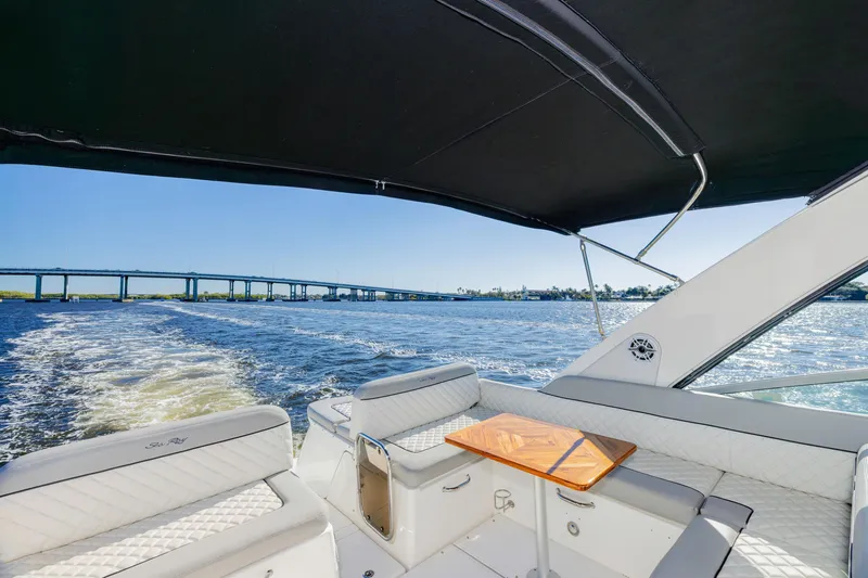 Slide: The Image of 2013 Sea Ray 370 Venture cruising on a sunny day, bridge in background. - 28