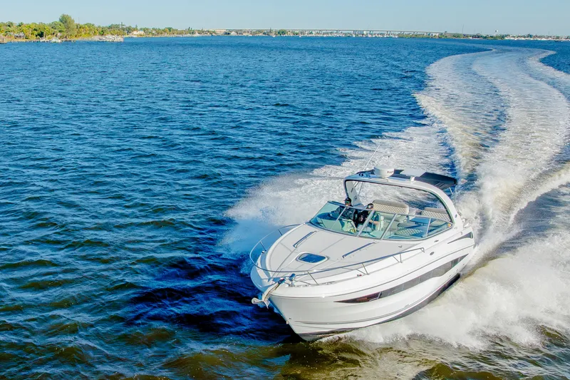 Slide: The Image of 2013 Sea Ray 370 Venture cruising on open water, leaving a wake behind. - 18