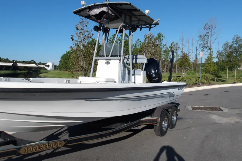 Slide: The Image of 2008 Ranger 2200 Bay Ranger boat on trailer, parked outdoors under clear blue sky. - 3