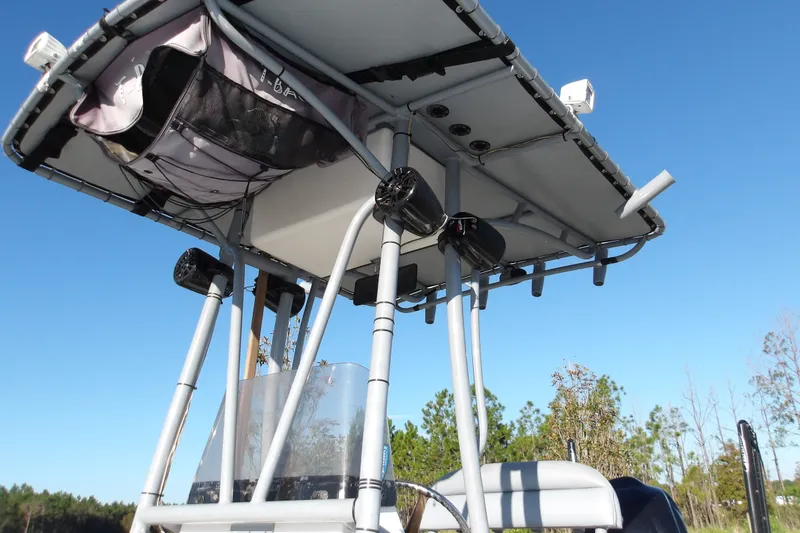 Slide: The Image of 2008 Ranger 2200 Bay Ranger boat with T-top and speakers against clear sky. - 14