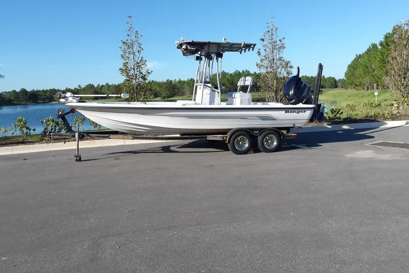 Slide: The Image of 2008 Ranger 2200 Bay Ranger boat on trailer by a lake. - 0