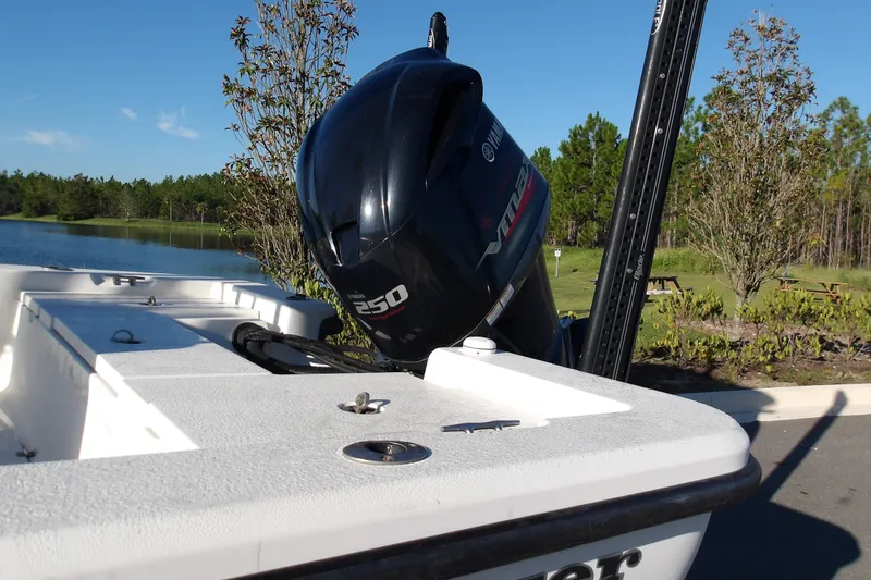 Slide: The Image of 2008 Ranger 2200 Bay Ranger boat with Yamaha 250 engine by a lake. - 10