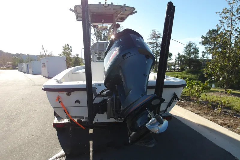 Slide: The Image of 2008 Ranger 2200 Bay Ranger boat with Yamaha outboard motor, parked outdoors. - 2