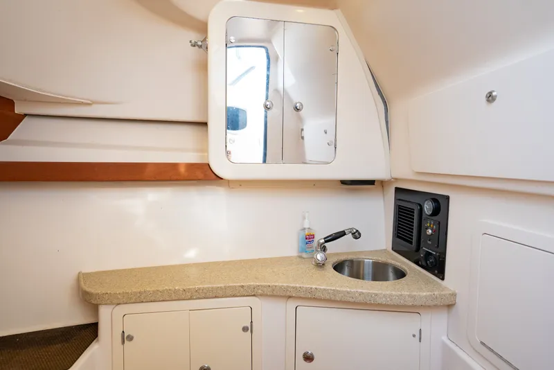 Slide: The Image of 2015 Grady-White Freedom 335 boat interior with sink and storage cabinets. - 42