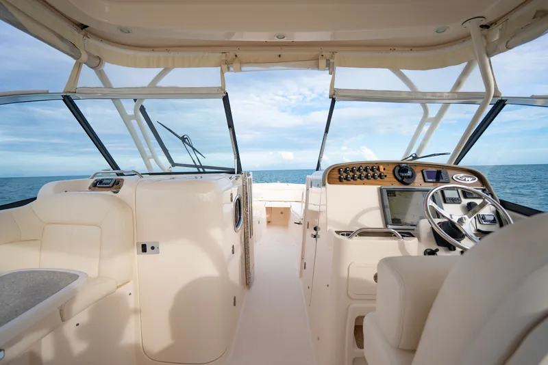 Slide: The Image of 2015 Grady-White Freedom 335 boat interior with ocean view, featuring helm and seating area. - 34