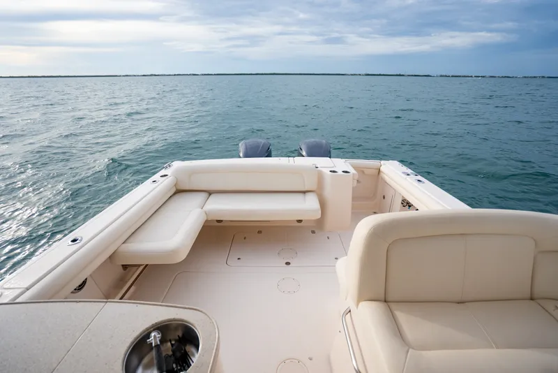 Slide: The Image of 2015 Grady-White Freedom 335 boat interior with ocean view, featuring comfortable seating. - 55