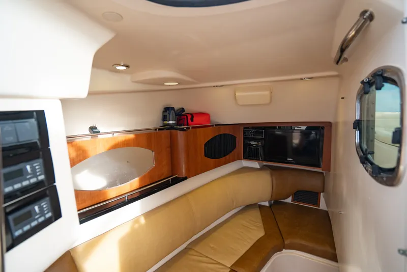 Slide: The Image of 2015 Grady-White Freedom 335 cabin interior with seating, storage, and entertainment system. - 48