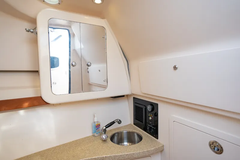 Slide: The Image of Interior of 2015 Grady-White Freedom 335 boat with sink and mirror cabinet. - 41