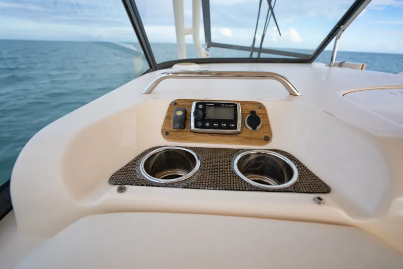 Slide: The Image of Control panel of 2015 Grady-White Freedom 335 boat with cup holders and ocean view. - 32