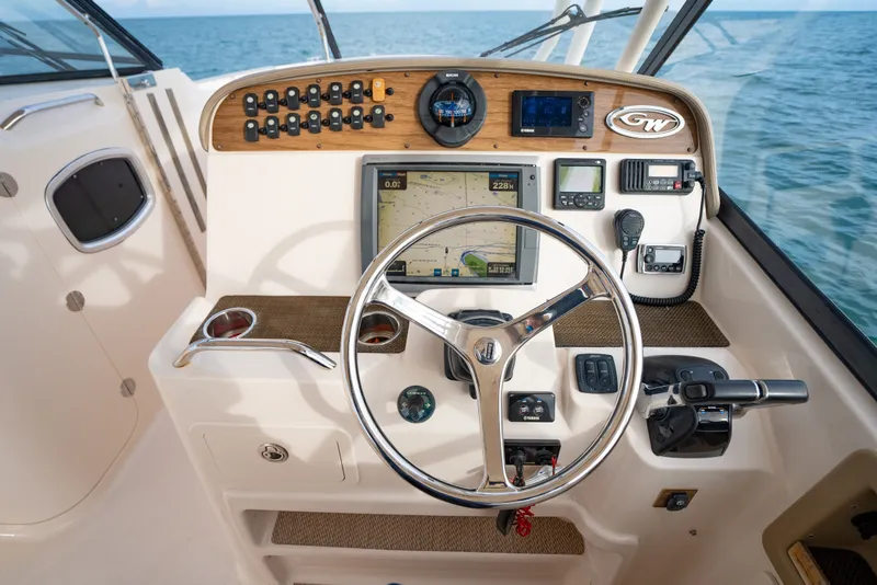Slide: The Image of Helm of 2015 Grady-White Freedom 335 boat with navigation controls and steering wheel. - 31
