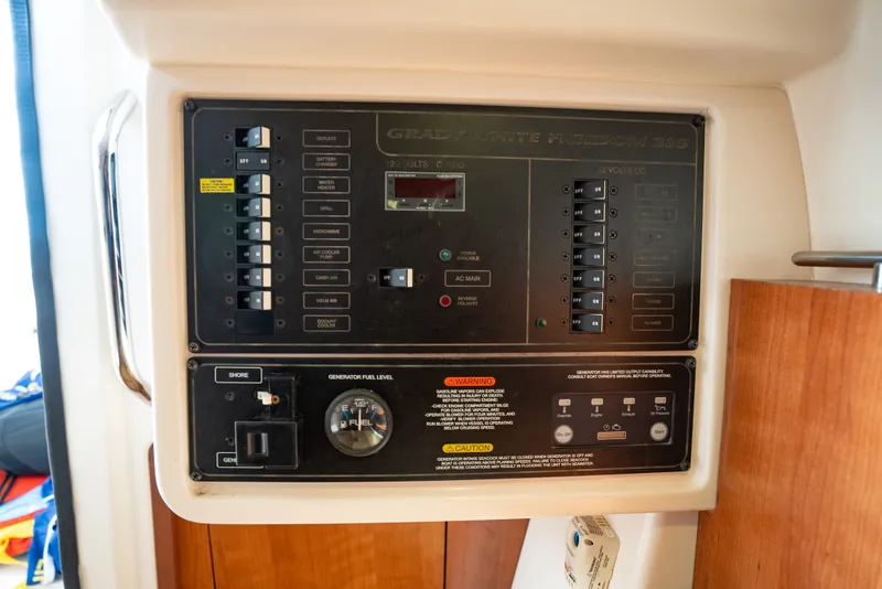 Slide: The Image of Electrical control panel of 2015 Grady-White Freedom 335 boat, showing switches and fuel gauge. - 52