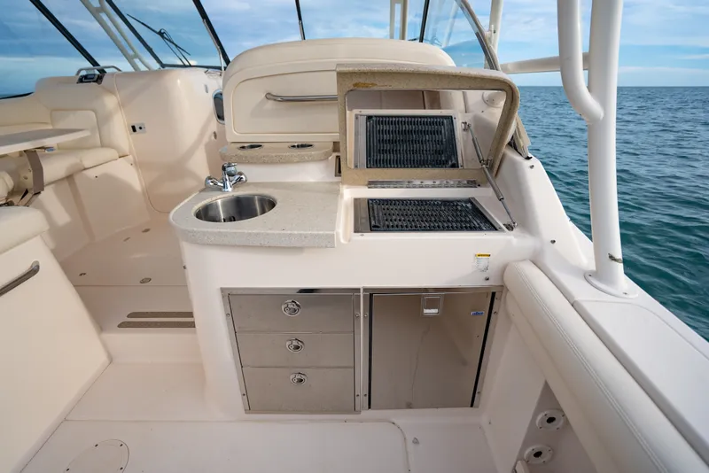 Slide: The Image of 2015 Grady-White Freedom 335 boat interior with kitchenette and ocean view. - 35