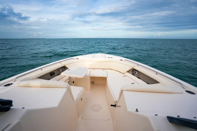 Slide: The Image of 2015 Grady-White Freedom 335 boat on open sea under cloudy sky. - 23