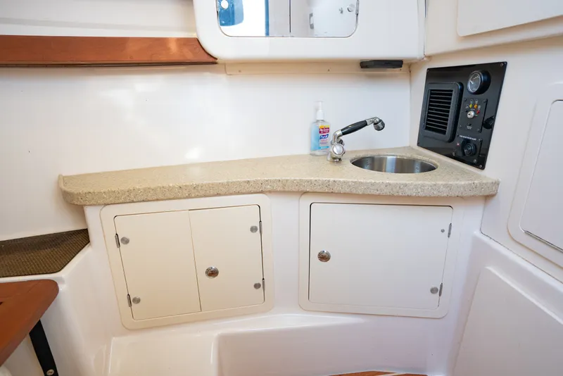 Slide: The Image of 2015 Grady-White Freedom 335 boat interior with sink and storage cabinets. - 44