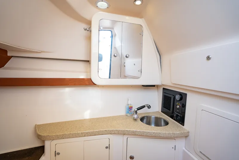 Slide: The Image of 2015 Grady-White Freedom 335 boat interior with sink and mirror. - 45