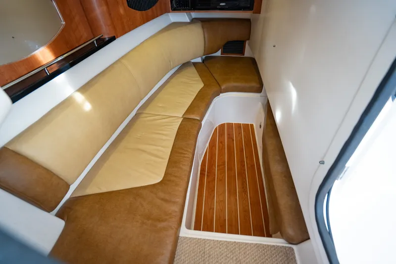 Slide: The Image of 2015 Grady-White Freedom 335 cabin interior with cushioned seating and wooden flooring. - 49