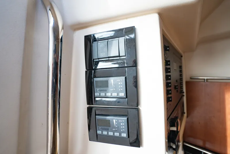 Slide: The Image of Control panel on a 2015 Grady-White Freedom 335 boat, featuring digital displays and switches. - 53