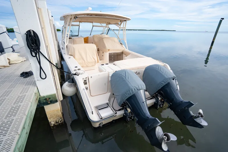 Slide: The Image of 2015 Grady-White Freedom 335 boat docked with dual outboard motors. - 19