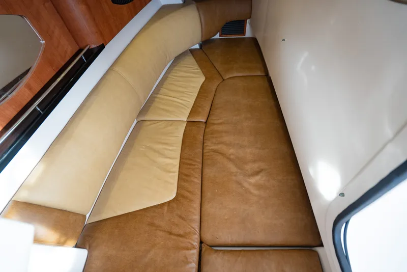 Slide: The Image of 2015 Grady-White Freedom 335 cabin interior with brown leather seating. - 50