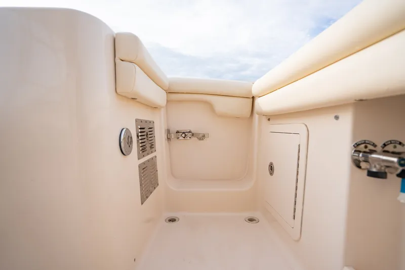 Slide: The Image of Interior view of a 2015 Grady-White Freedom 335 boat, showcasing storage compartments. - 38