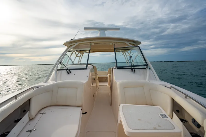 Slide: The Image of 2015 Grady-White Freedom 335 boat on open water under cloudy sky. - 26