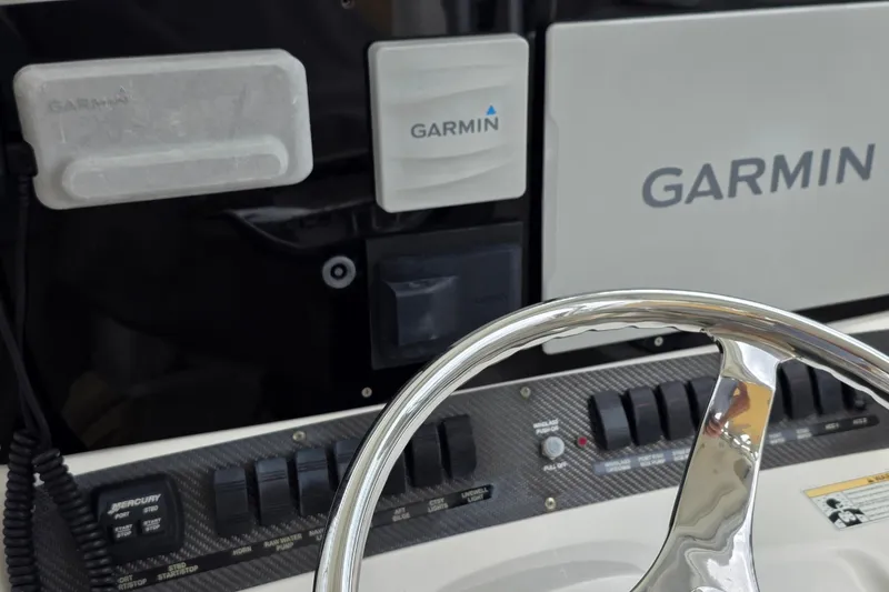 Slide: The Image of Dashboard of a 2007 Boston Whaler 305 Conquest with Garmin navigation equipment. - 52