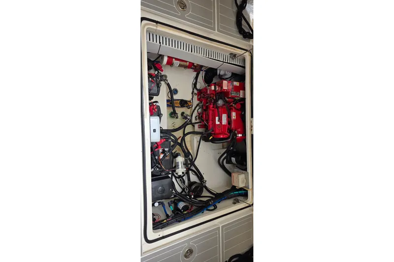 Slide: The Image of Engine compartment of a 2007 Boston Whaler 305 Conquest, showcasing wiring and components. - 53