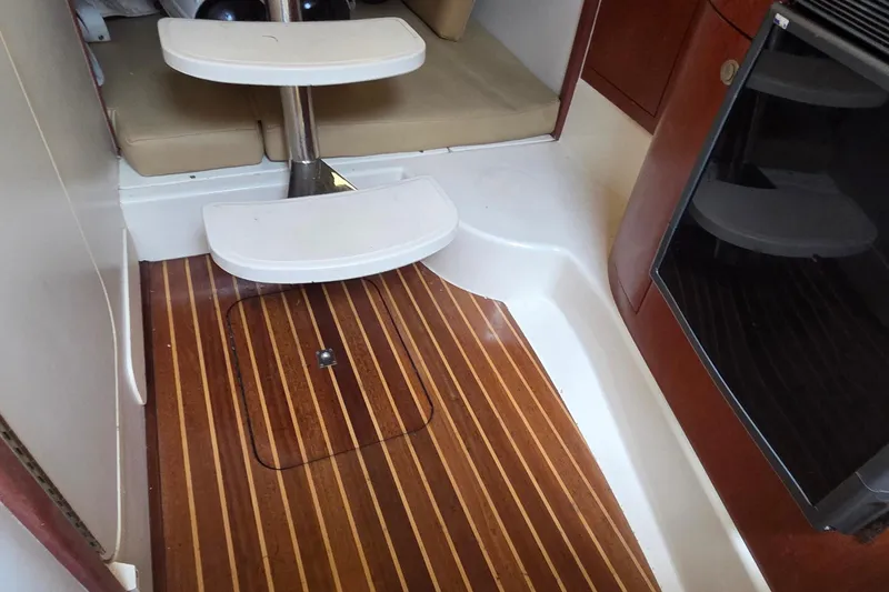 Slide: The Image of Interior of 2007 Boston Whaler 305 Conquest with wooden flooring and compact seating area. - 43