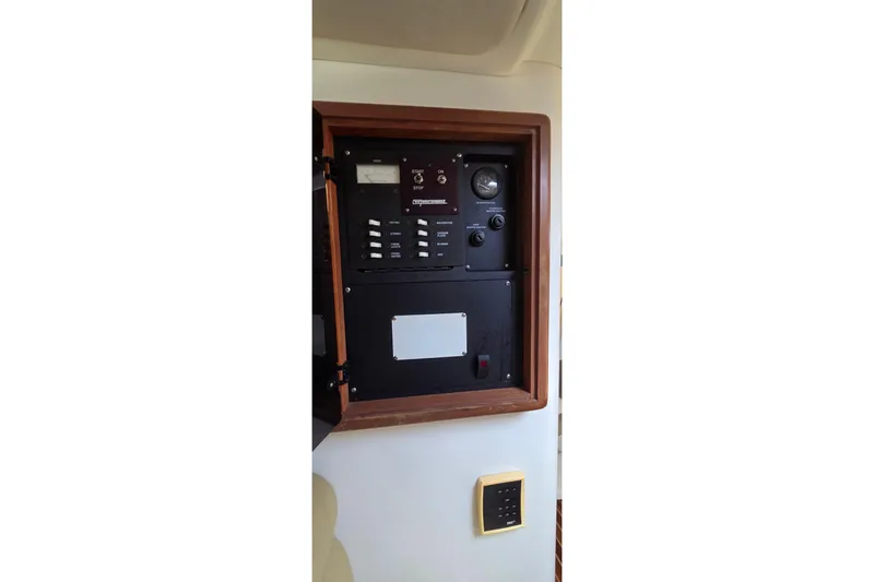 Slide: The Image of Electrical panel of a 2007 Boston Whaler 305 Conquest boat, featuring control switches. - 40