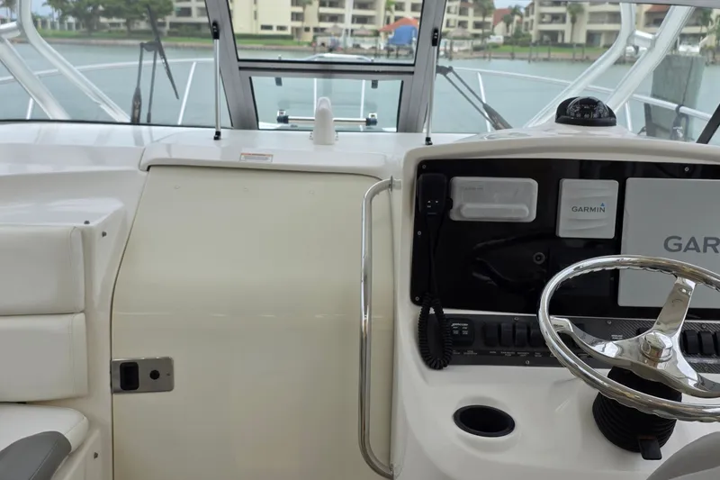 Slide: The Image of 2007 Boston Whaler 305 Conquest helm with Garmin navigation system and steering wheel. - 51