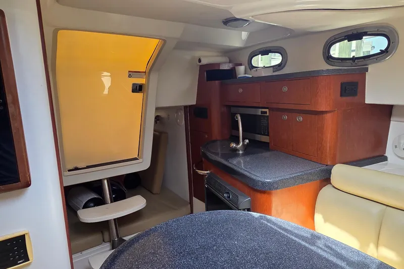 Slide: The Image of Interior of 2007 Boston Whaler 305 Conquest boat with kitchenette and seating area. - 38