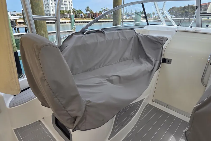 Slide: The Image of 2007 Boston Whaler 305 Conquest boat interior with covered seating area. - 33