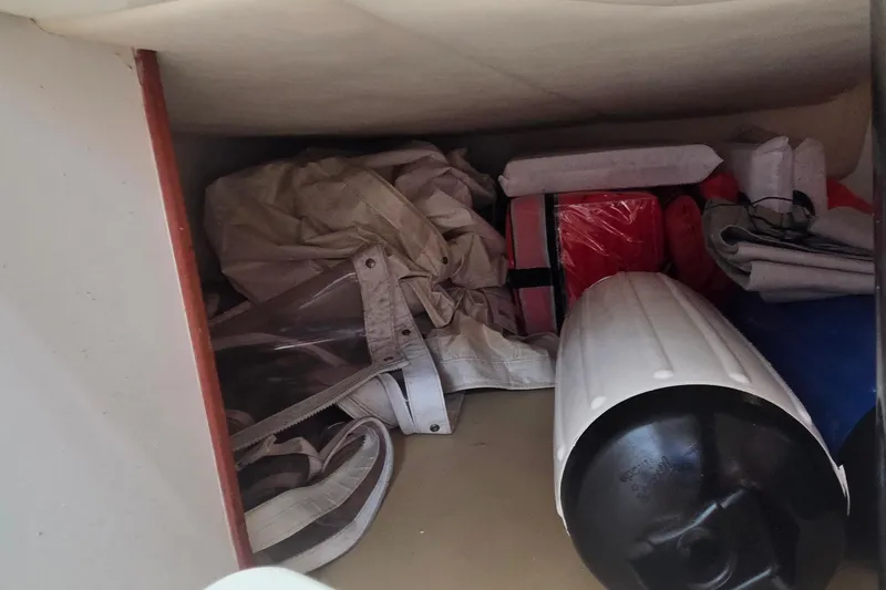 Slide: The Image of Storage compartment in a 2007 Boston Whaler 305 Conquest boat with various equipment. - 47