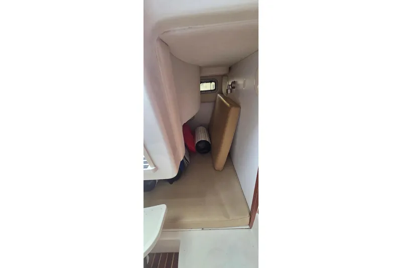 Slide: The Image of 2007 Boston Whaler 305 Conquest cabin interior with cushions and window. - 37