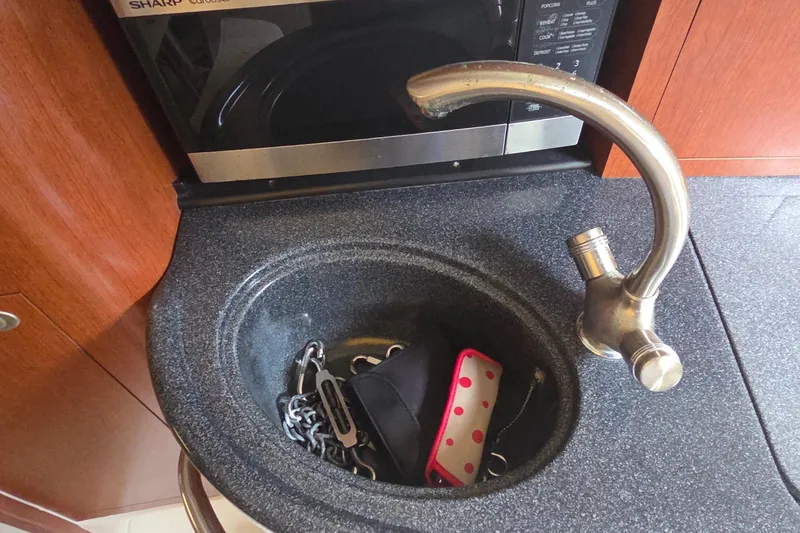 Slide: The Image of Boat sink with faucet and items, 2007 Boston Whaler 305 Conquest interior. - 46