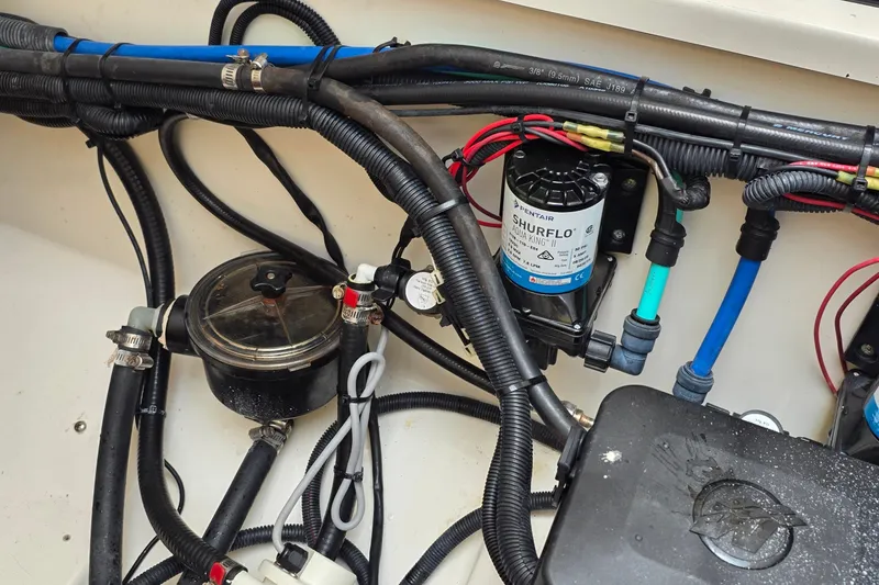 Slide: The Image of 2007 Boston Whaler 305 Conquest boat wiring and pump system detail. - 55