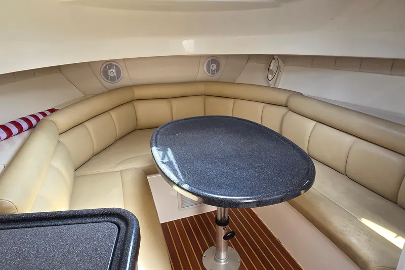Slide: The Image of Interior of 2007 Boston Whaler 305 Conquest with beige seating and oval table. - 36