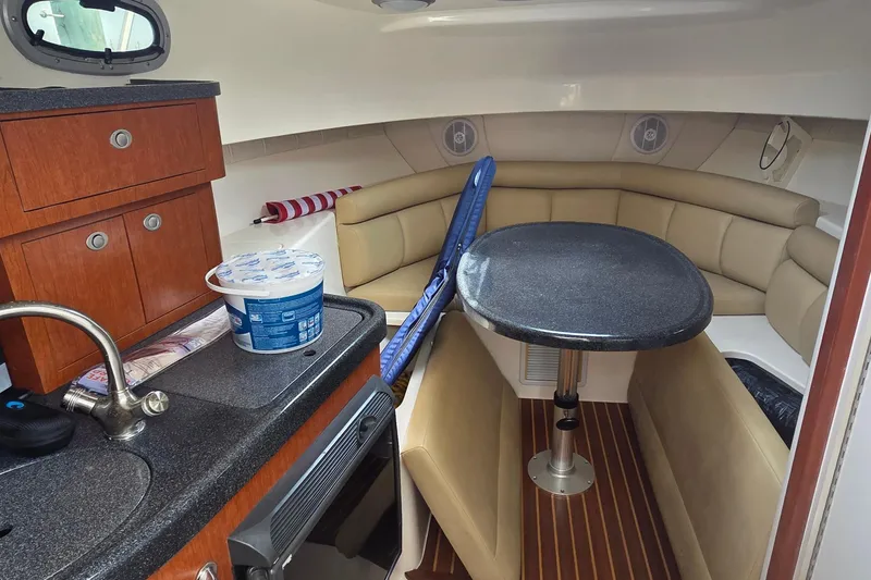 Slide: The Image of Interior of 2007 Boston Whaler 305 Conquest with kitchenette and seating area. - 35