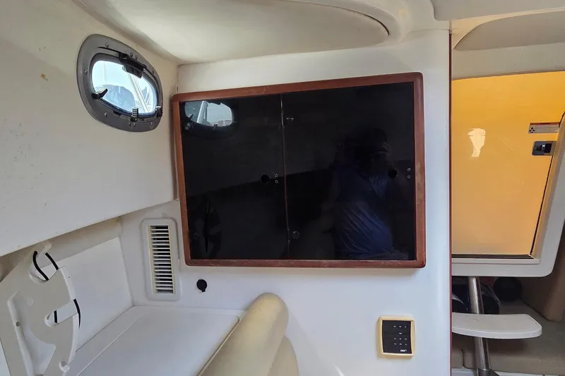 Slide: The Image of Interior cabin of 2007 Boston Whaler 305 Conquest with window and storage cabinet. - 39