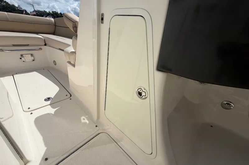 Slide: The Image of 2014 Sea Ray 240 Sundeck interior with seating and storage compartments. - 44