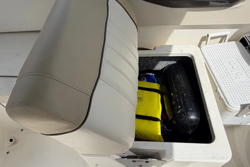 Slide: The Image of A seat on a Sea Ray 240 Sundeck boat with storage space underneath. - 25