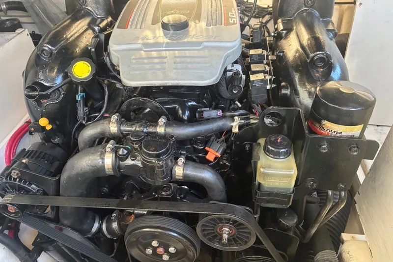 Slide: The Image of Engine of a 2014 Sea Ray 240 Sundeck boat, showcasing mechanical components. - 54
