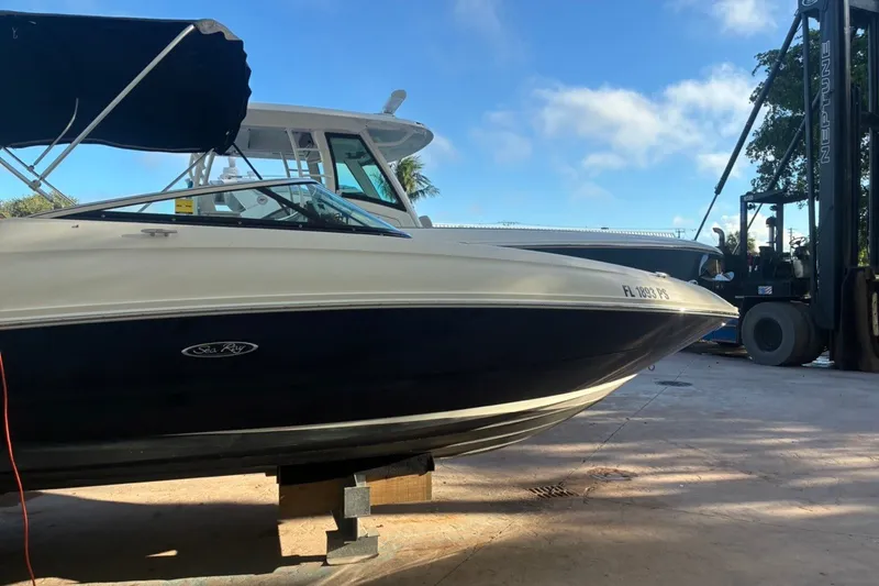 Slide: The Image of 2014 Sea Ray 240 Sundeck boat on dry dock with forklift in background. - 3